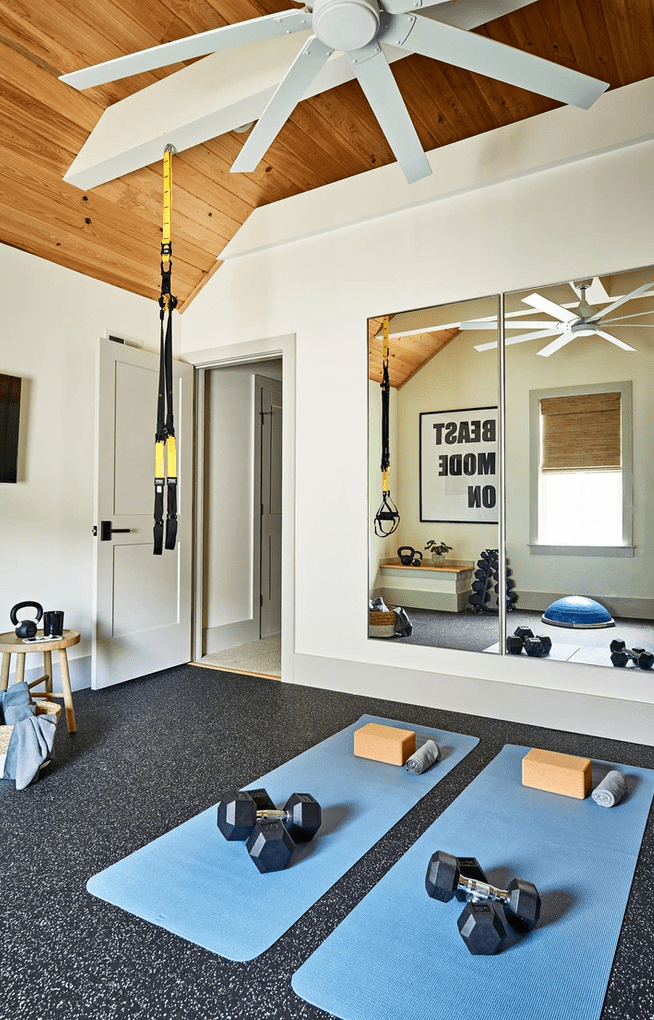 home gym with mirrors and yoga mats