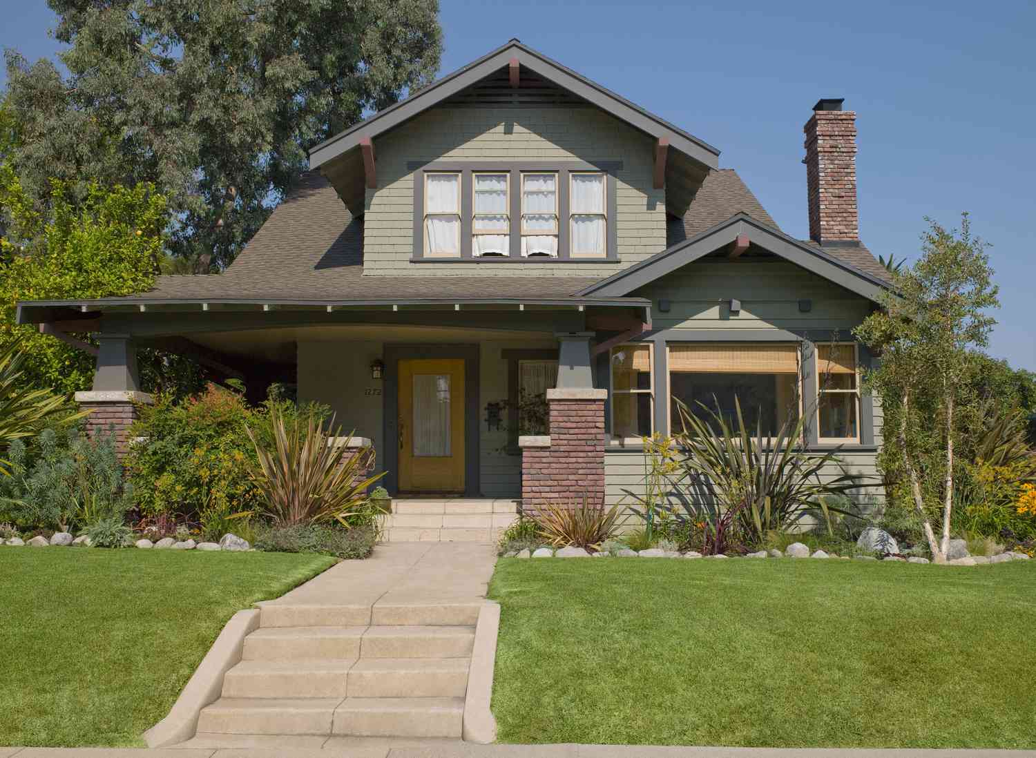 Craftsman house with a muted green monochromatic color scheme