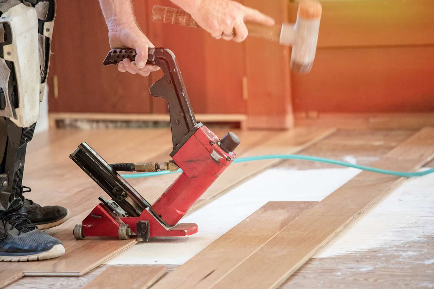 Person using a hardwood nail gun