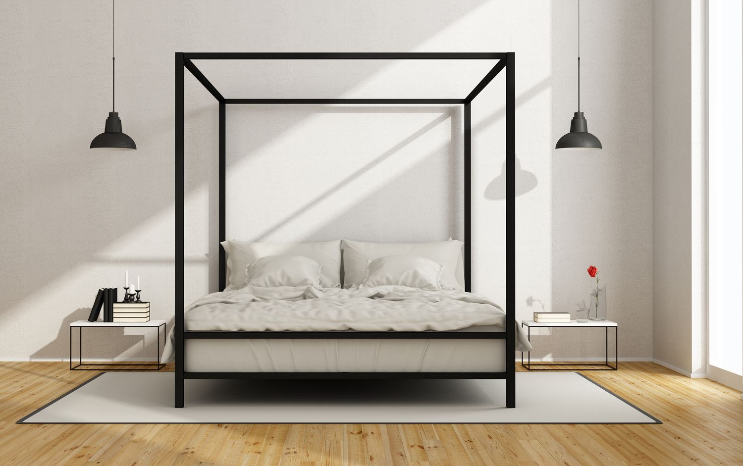 Un cadre de lit contemporain à baldaquin noir dans une chambre blanche.