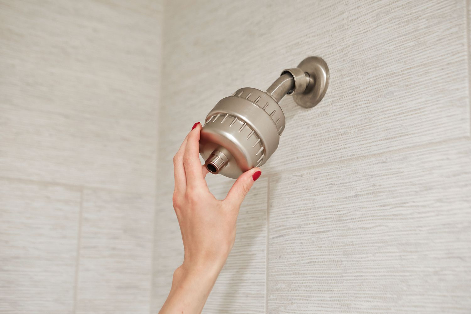 In-line shower filter added to shower arm