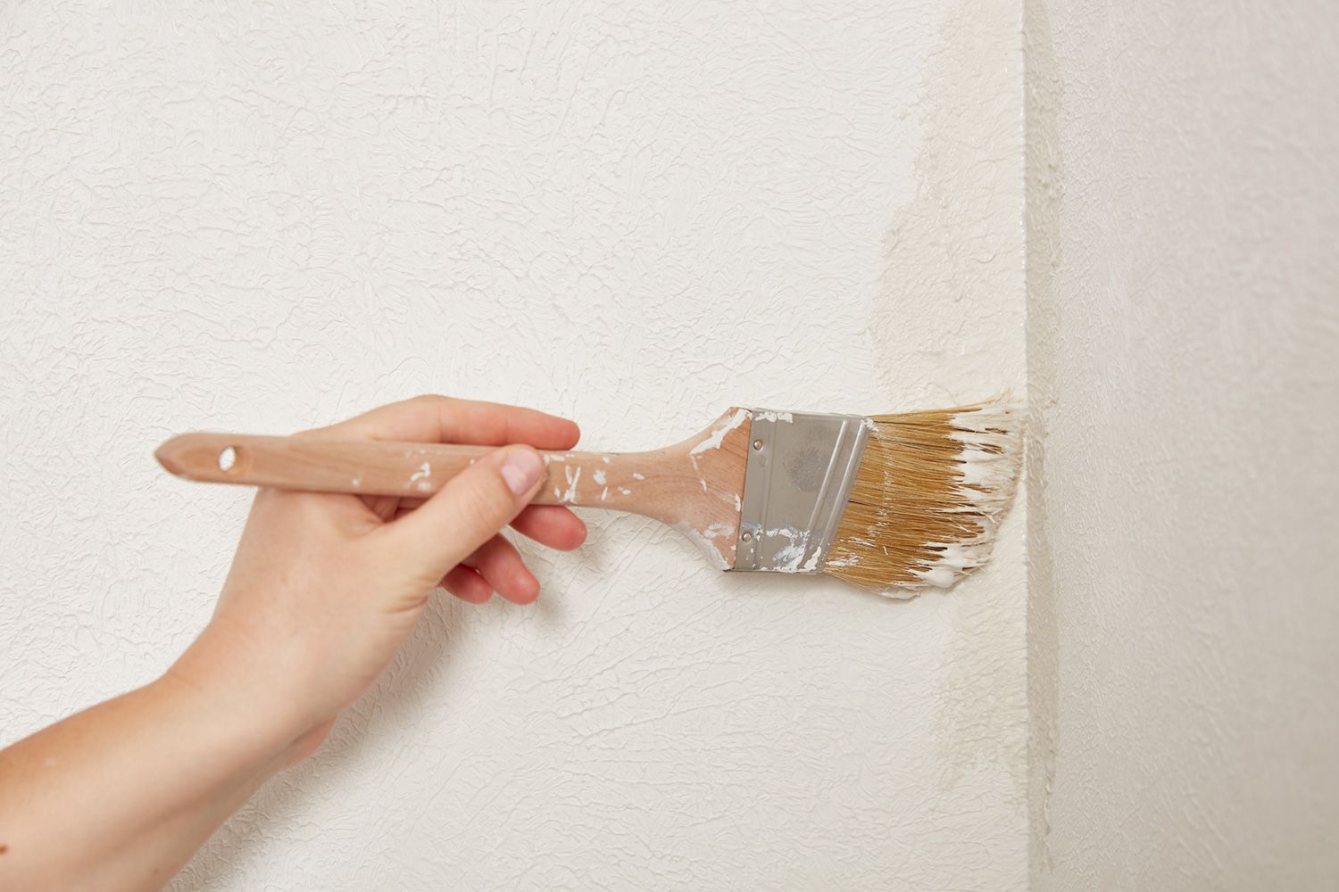 Use flat edge of paintbrush for tight areas