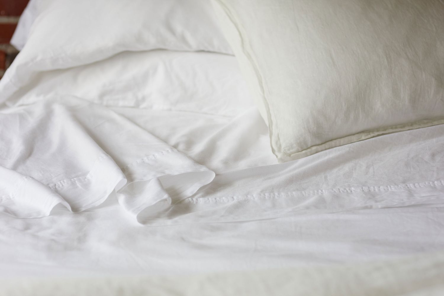 White light cotton sheets covering bed 