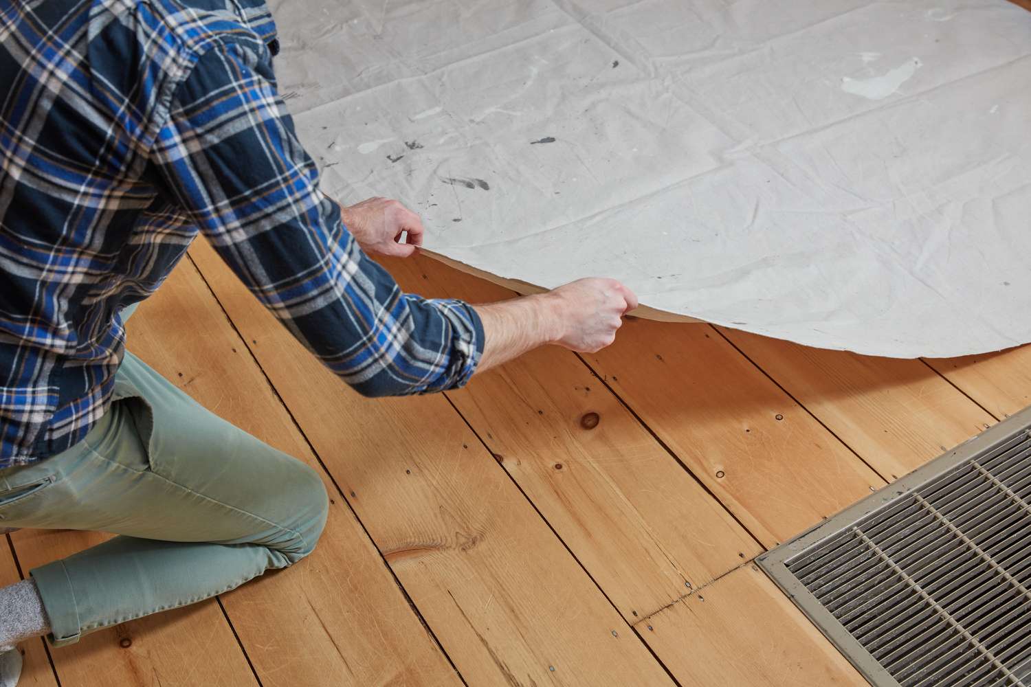 Drop cloth placed over wood floor for protection