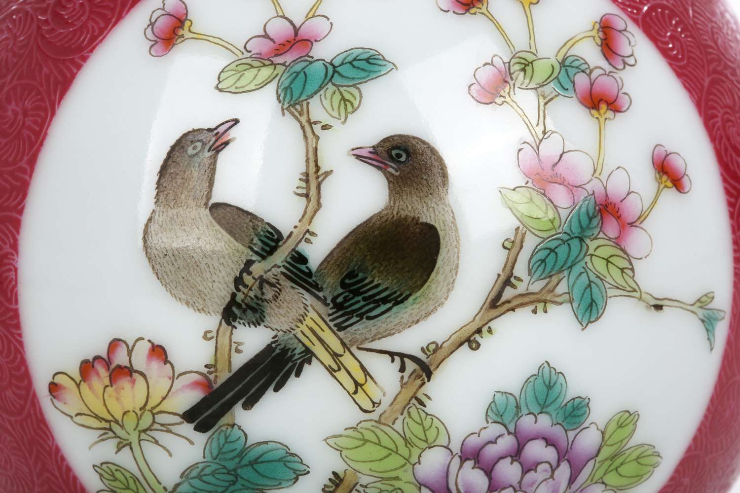 close up detail of a pair of magpies on a porcelain vase