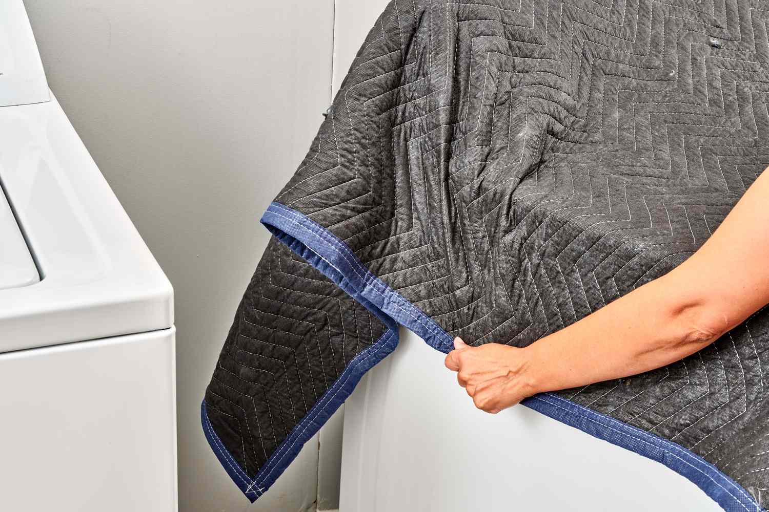 Moving blankets wrapped around washing machine for moving