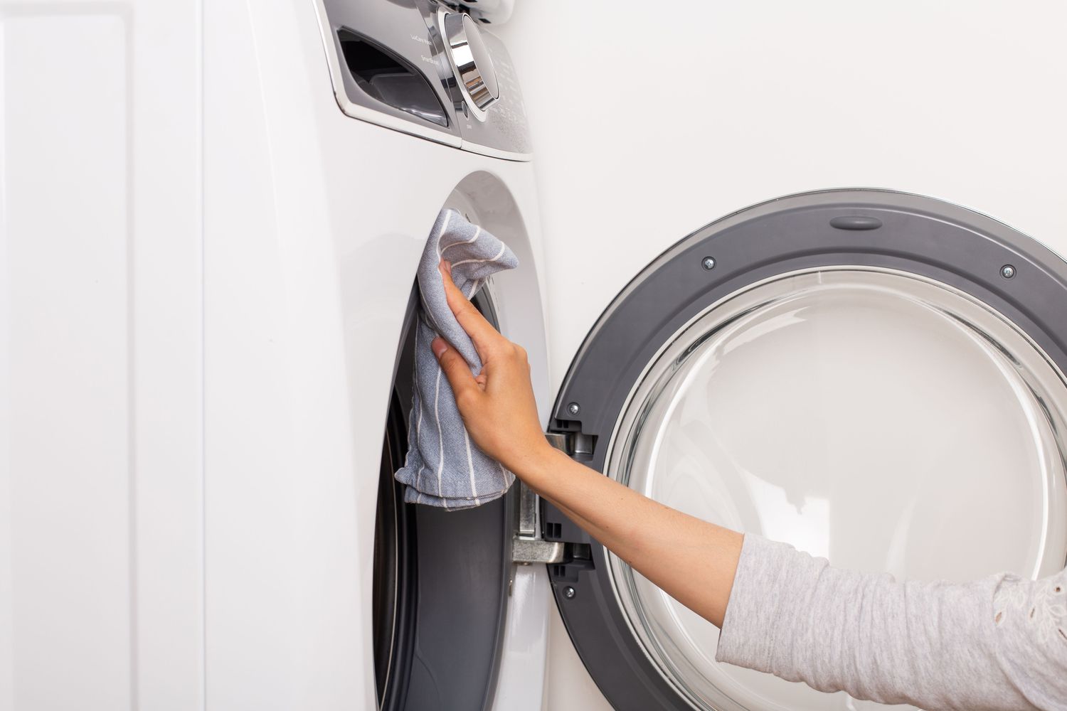 Person wiping down a dryer drum