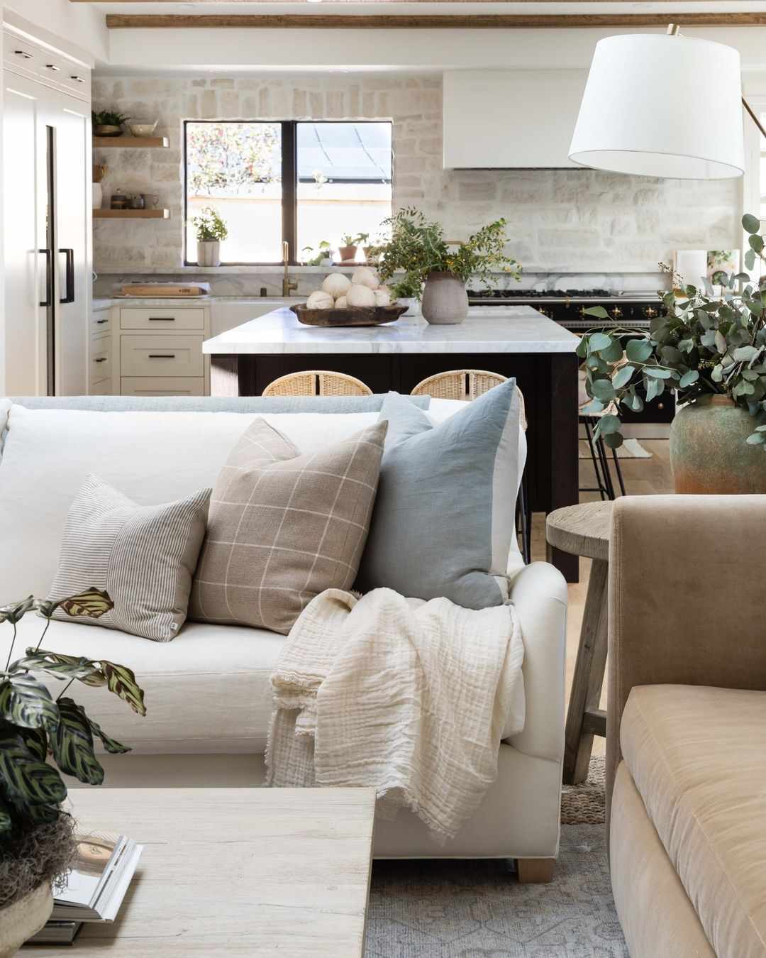 Checkerboard neutral throw pillow on couch.