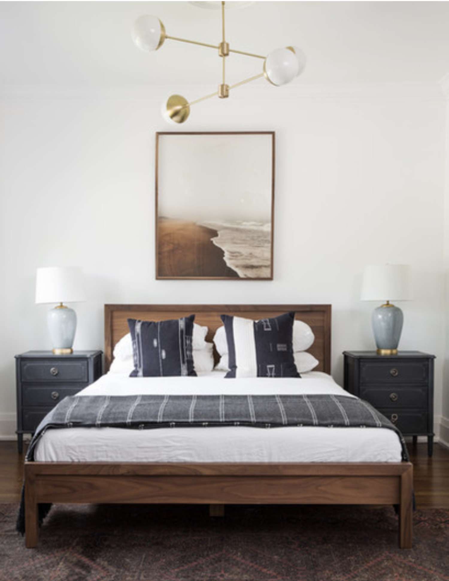 dormitorio con cabecero de madera, combinación de colores azul y blanco y marrón, lámpara moderna en el techo