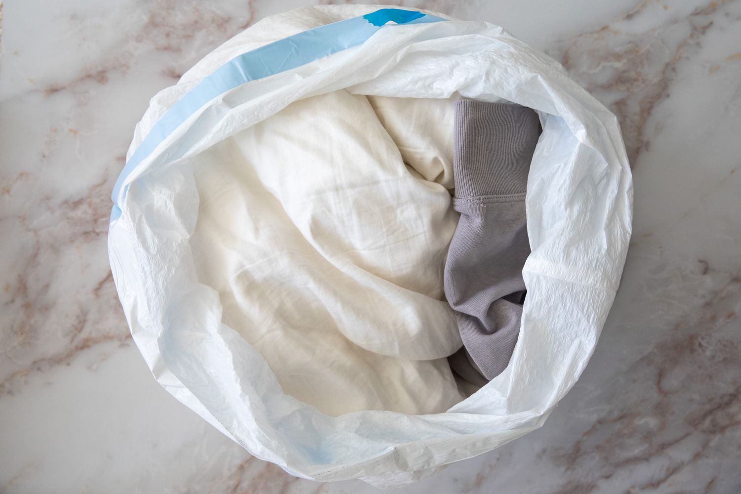Bug infested clothes separated into plastic trash bag