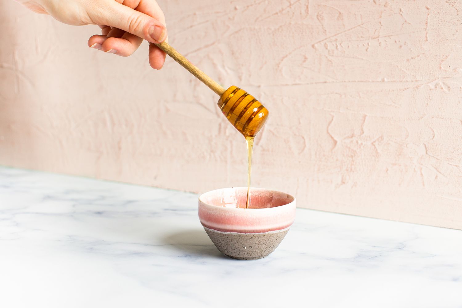 honey dripping into a bowl