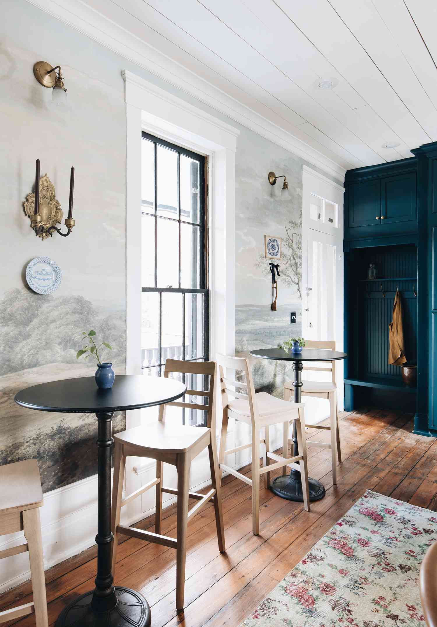 the butcher rose house with mural wallpaper and bistro chairs