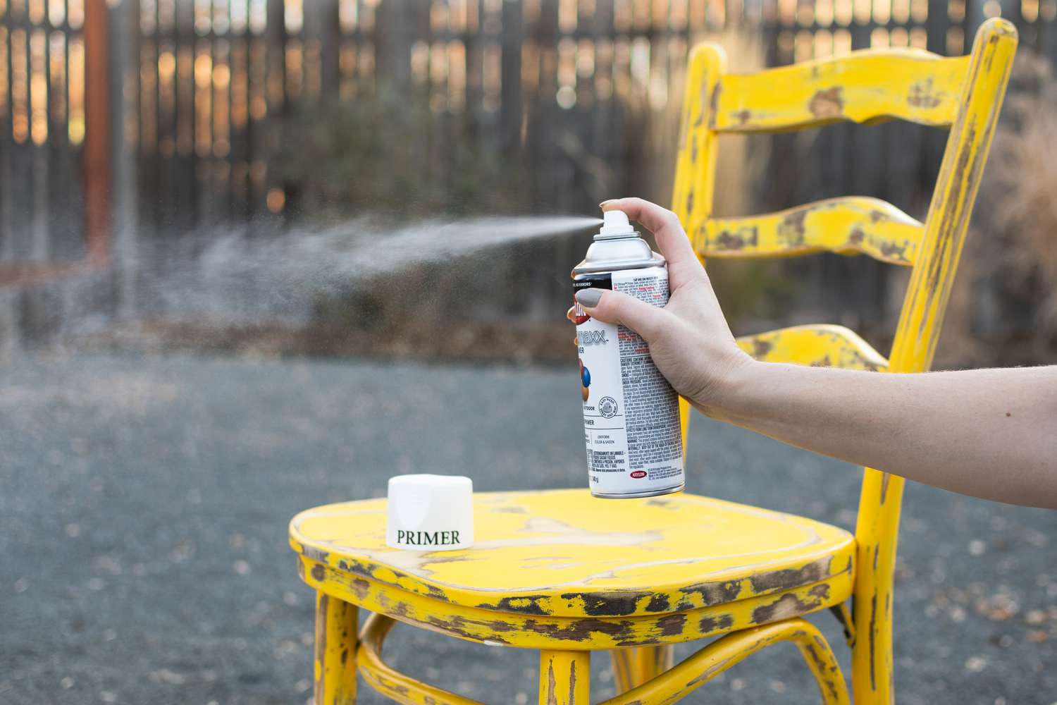 Primer sprayed to test nozzle in front of yellow chair