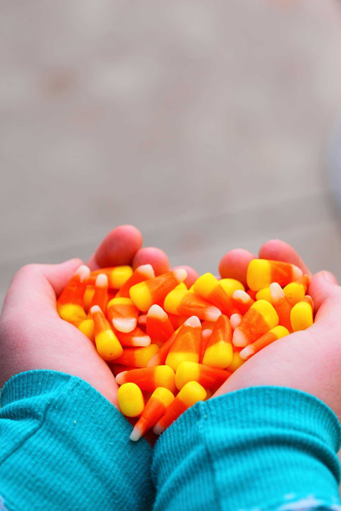 Hands holding candy corn