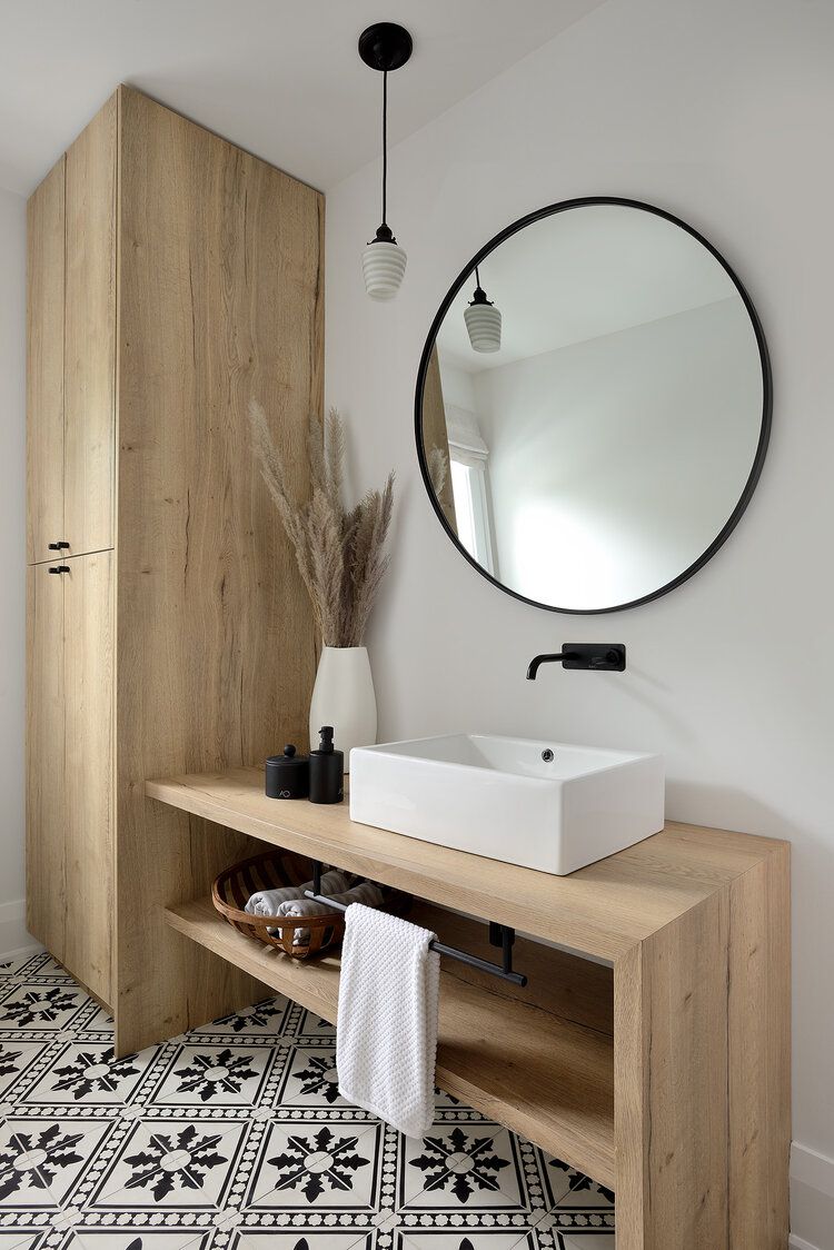 Um banheiro neutro com penteadeira de madeira e armário de armazenamento