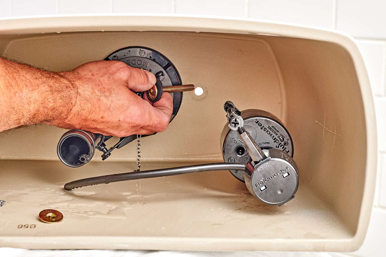 Pernos nuevos de la cisterna insertados en el orificio de la parte inferior de la cisterna del inodoro