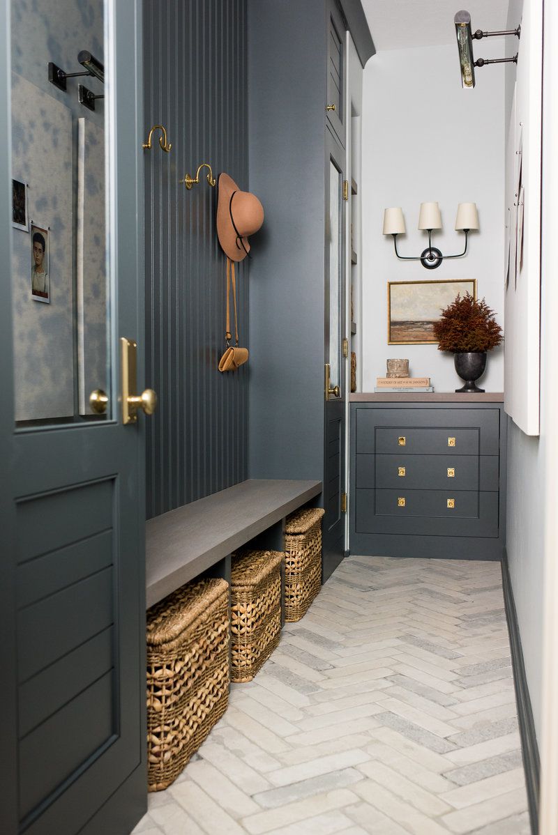 blue mudroom with wicker baskets underneath bench