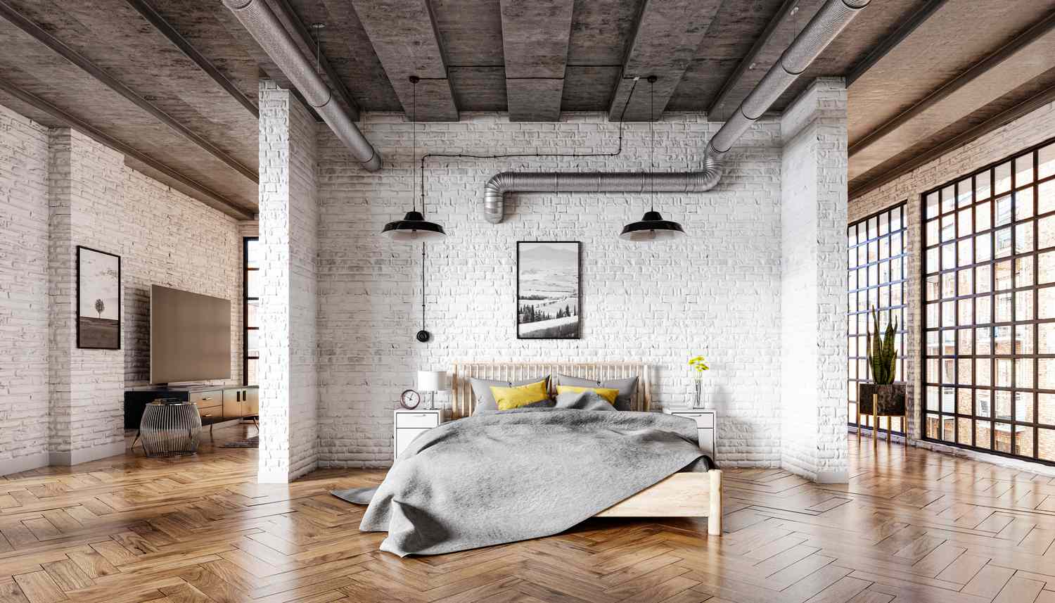 Chambre à coucher dans un intérieur de loft avec un mur de briques, un parquet et un plafond en béton