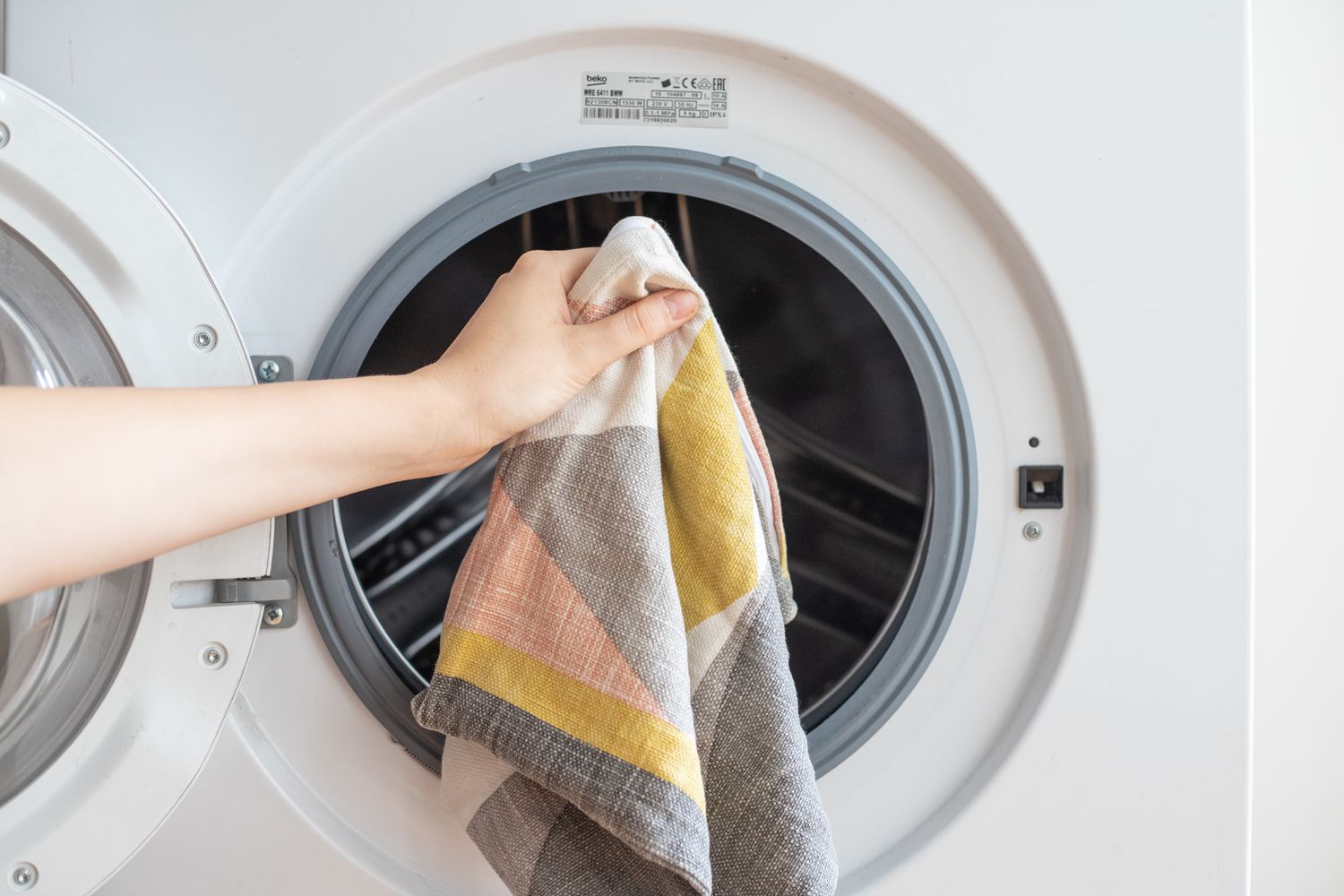 Patterned throw pillow cover placed inside washing machine