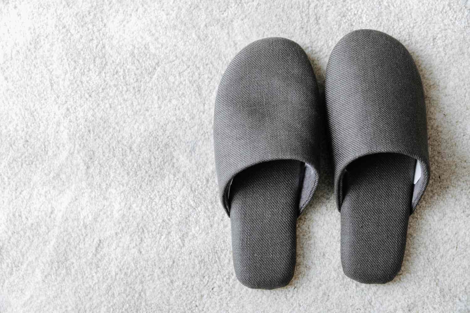 High Angle View Of Gray Flip-Flops On Carpet