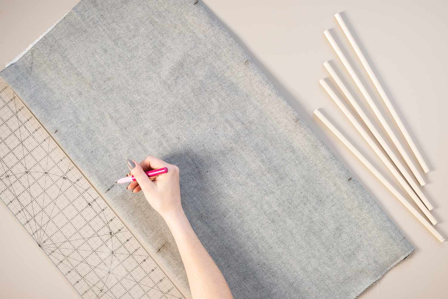 Dowel rod locations marked on wrong side of fabric next to ruler