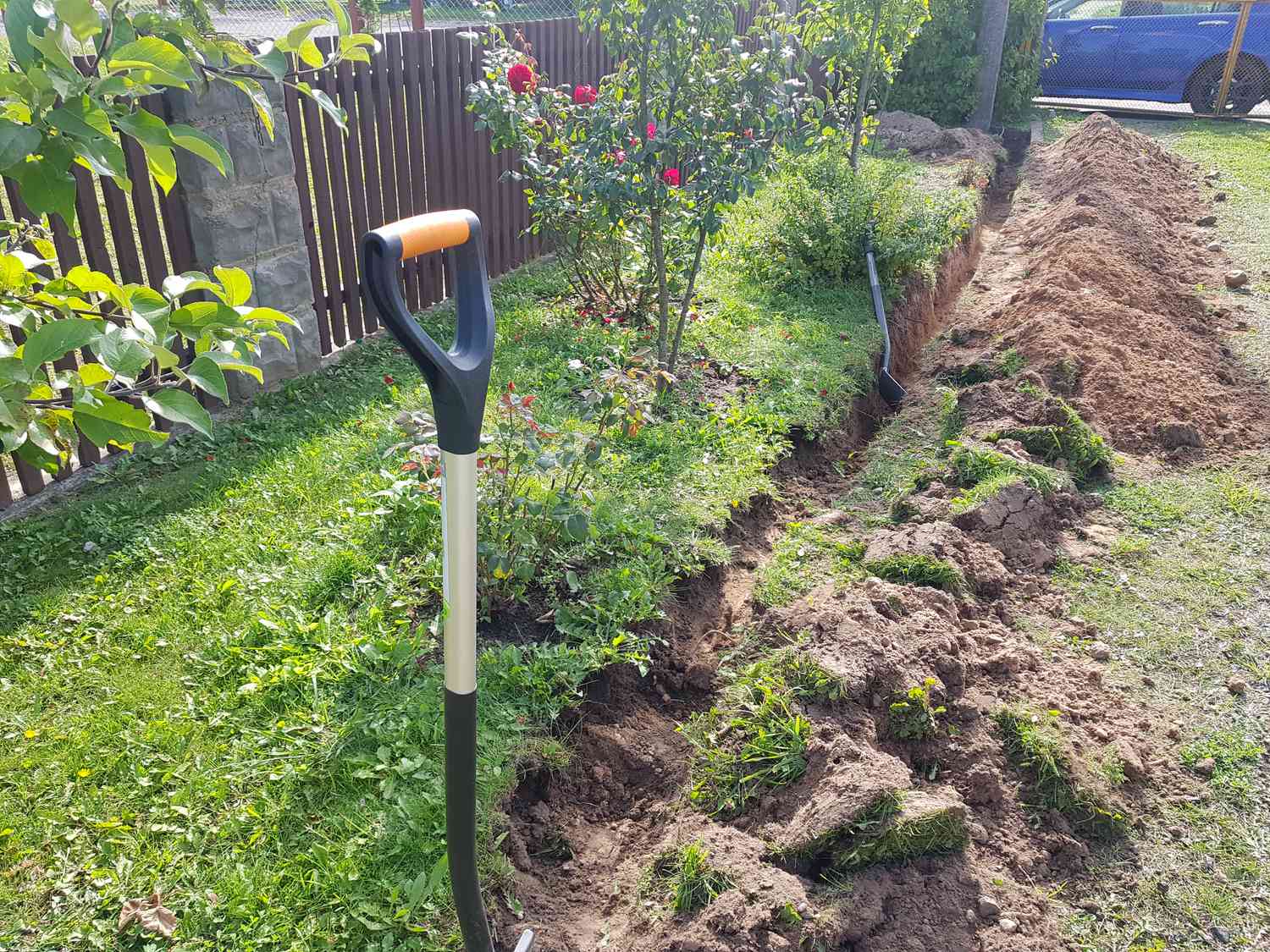 Shovel sticks out in ground on a personal plot
