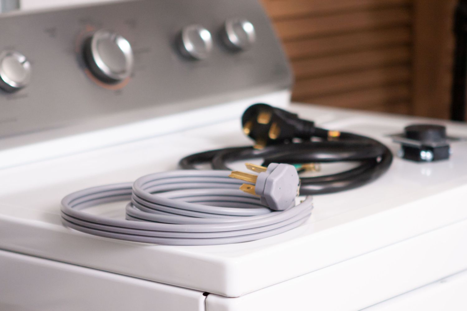 3 and 4 prong dryer cords on top of a dryer