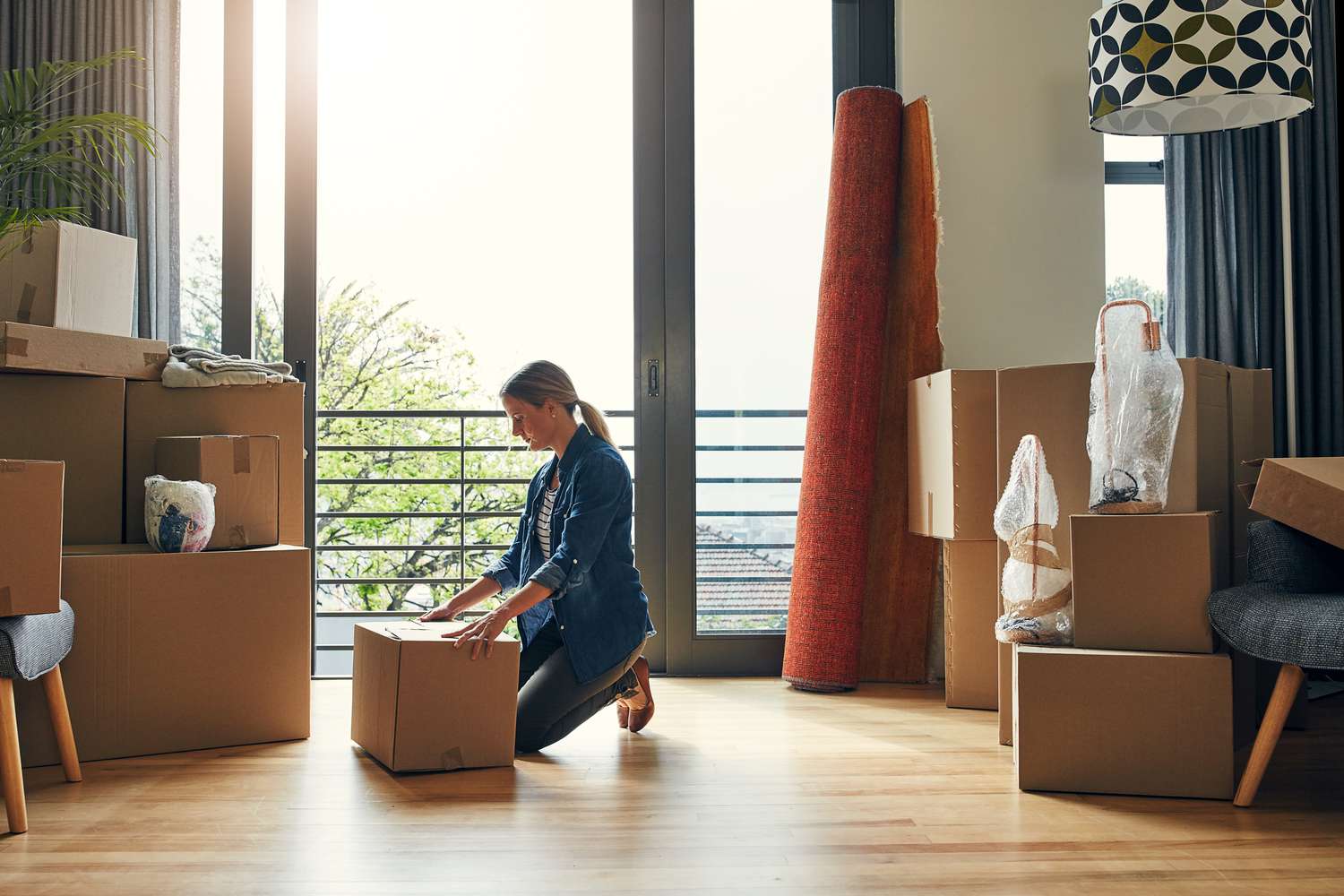 Women moving box around in her new home