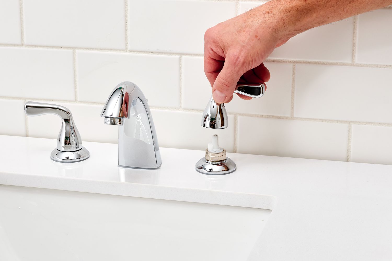 Faucet handles removed from setscrews in sink 