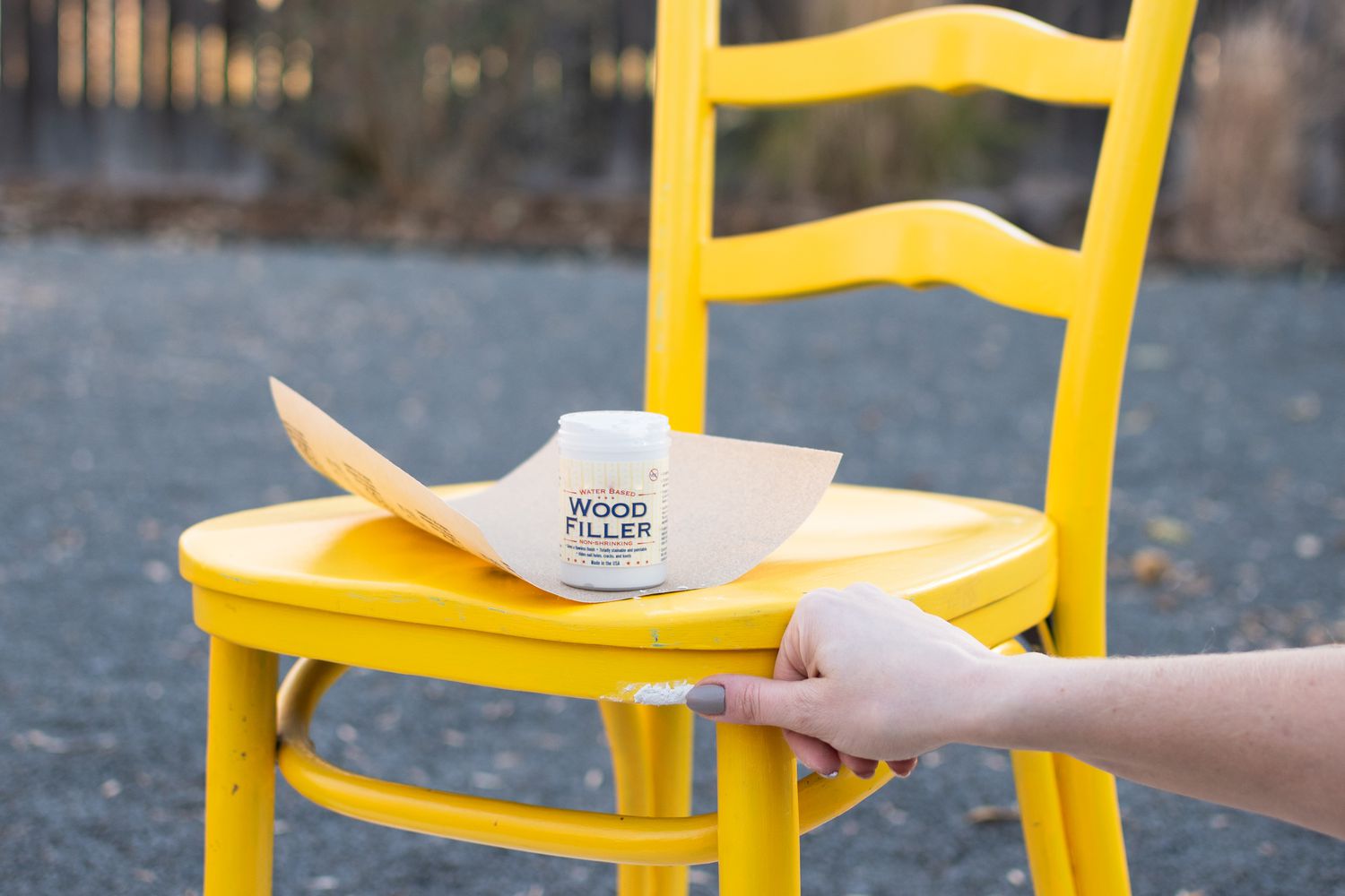 Wood filler placed over dents in yellow chair