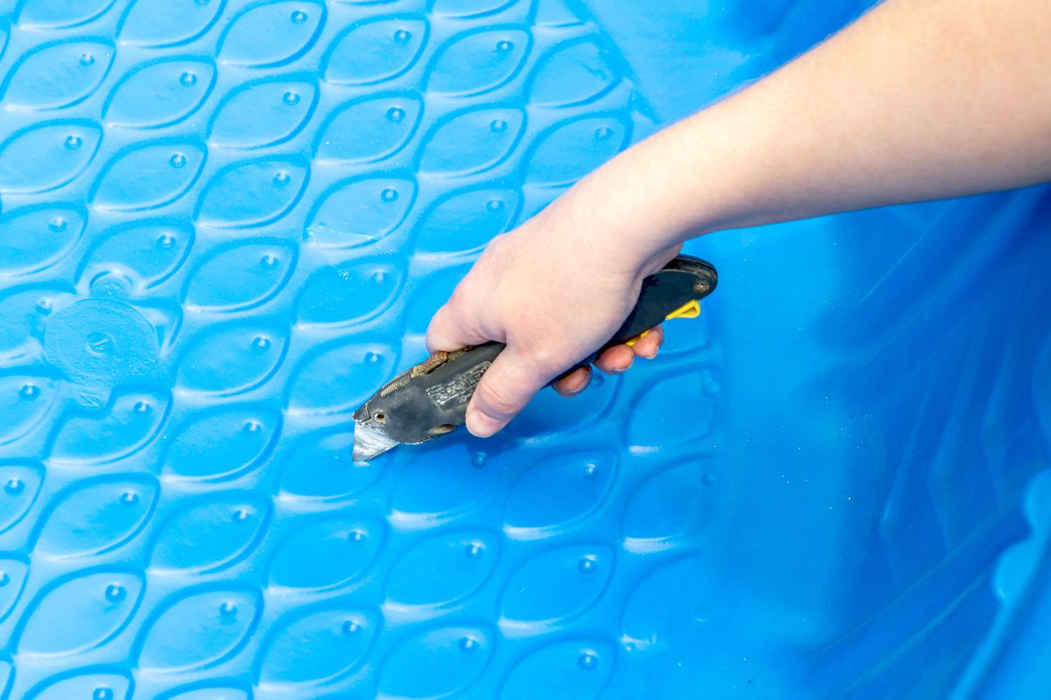 Drainage holes cut with utility knife in bottom of kiddie pool