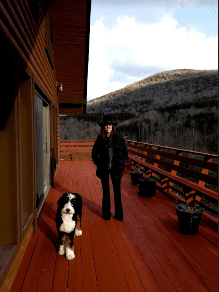 Hannah on her cabin deck with dog.