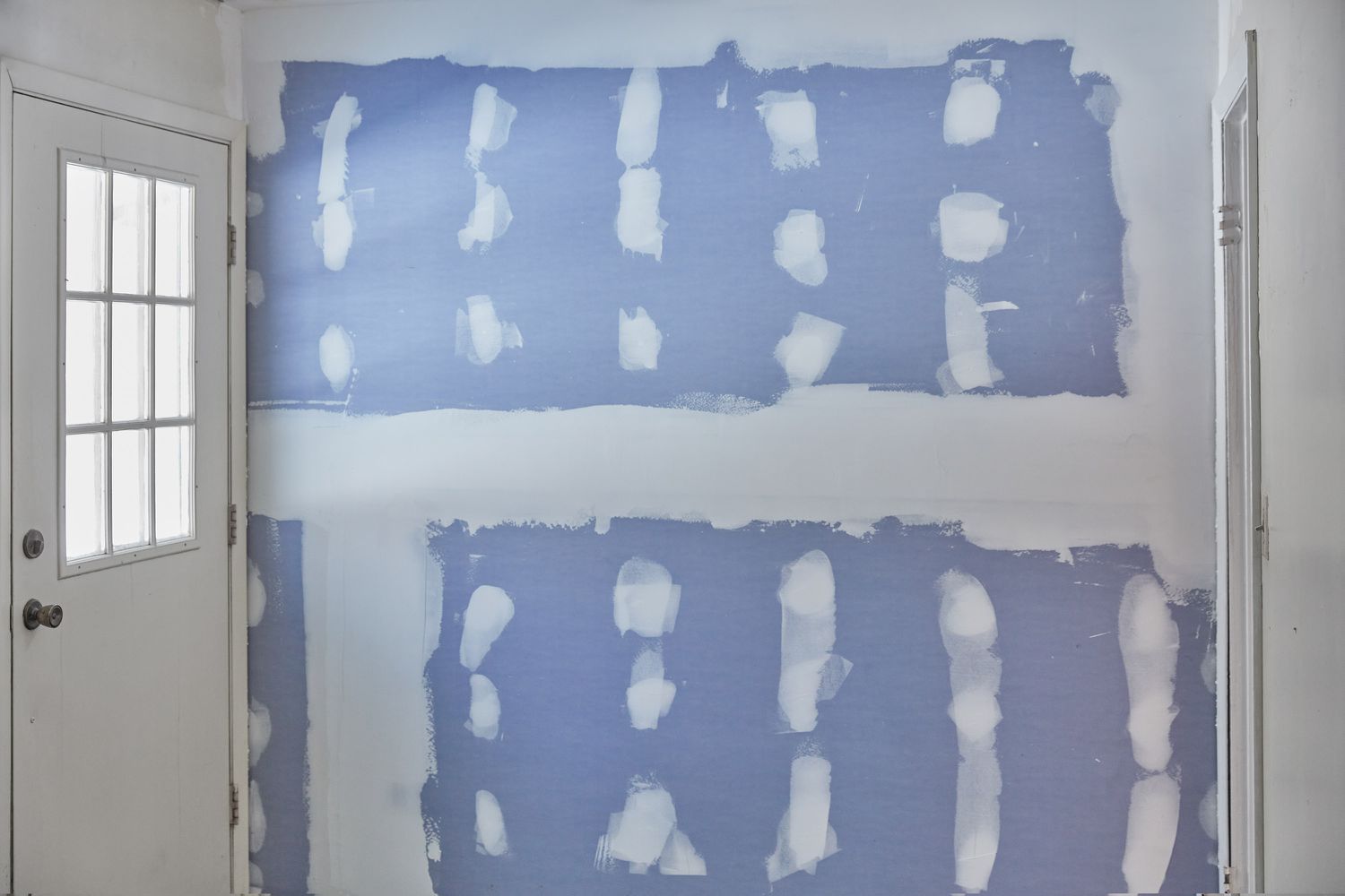 Joint compound drying on blue dry wall