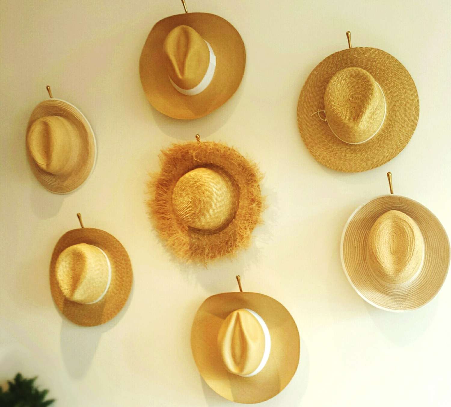 straw hats on wall