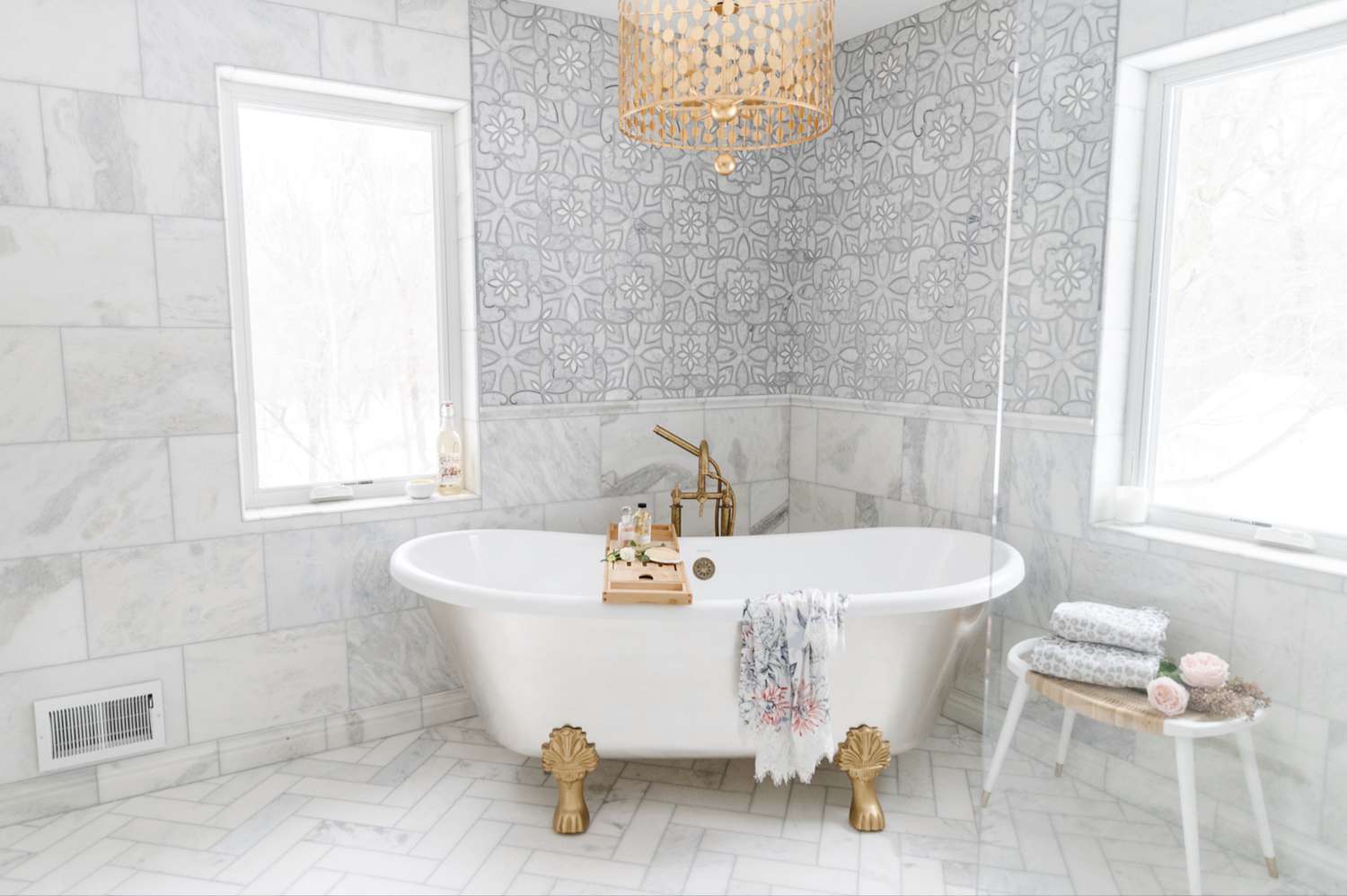 marble bathroom with gold chandelier