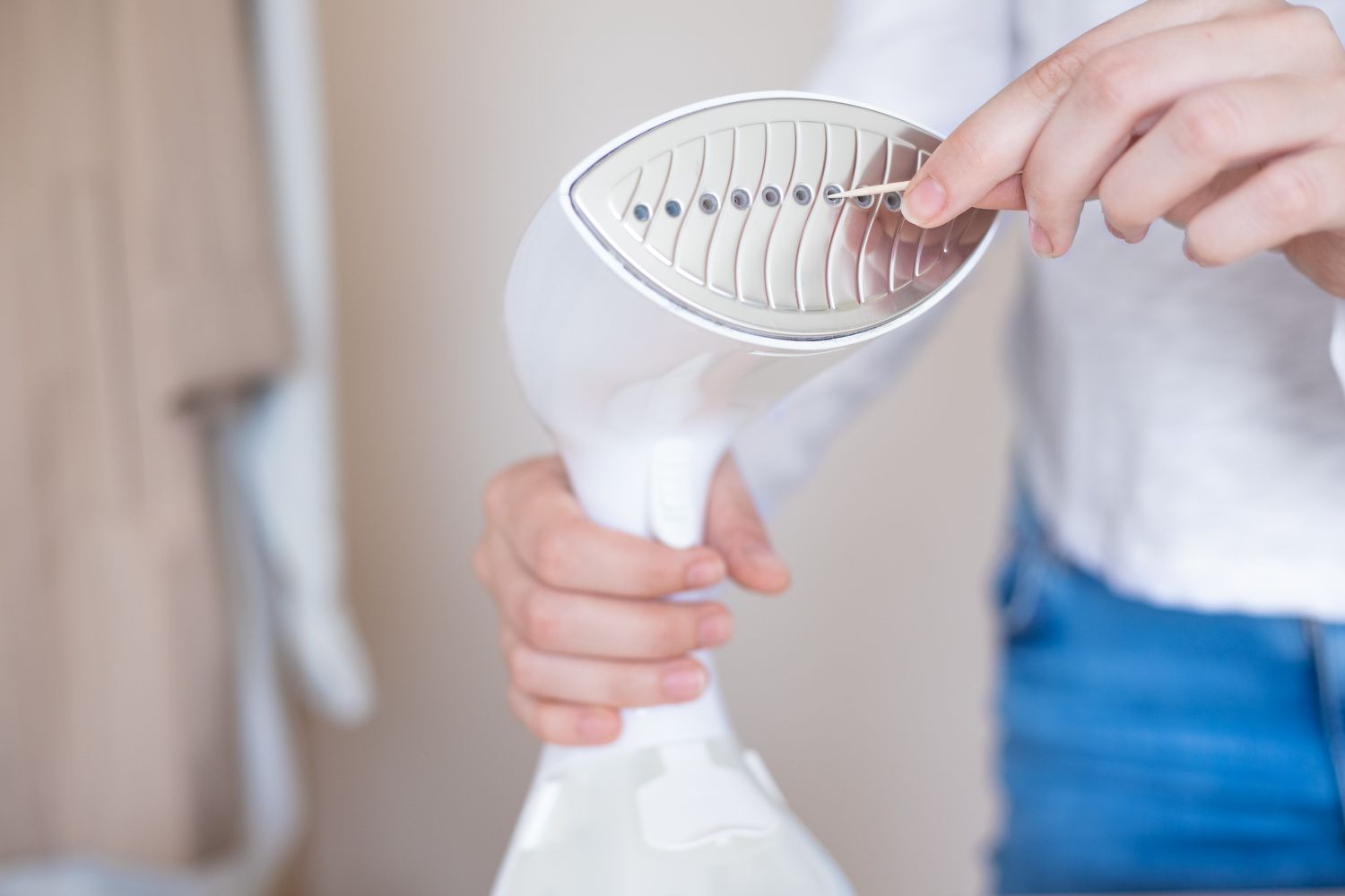 Toothpick removing clogged holes in clothes steamer nozzle