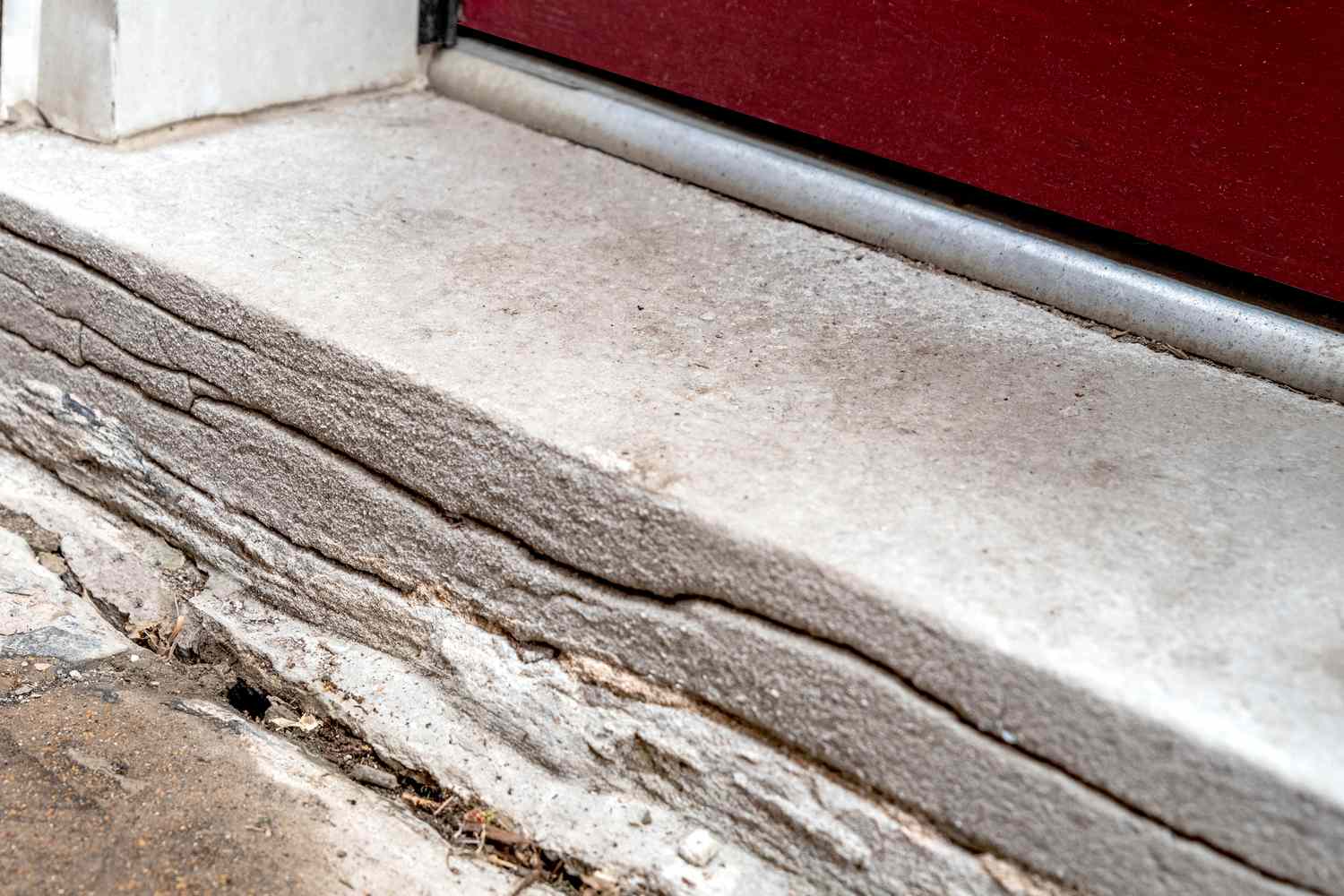 Doorway step with cracks in front