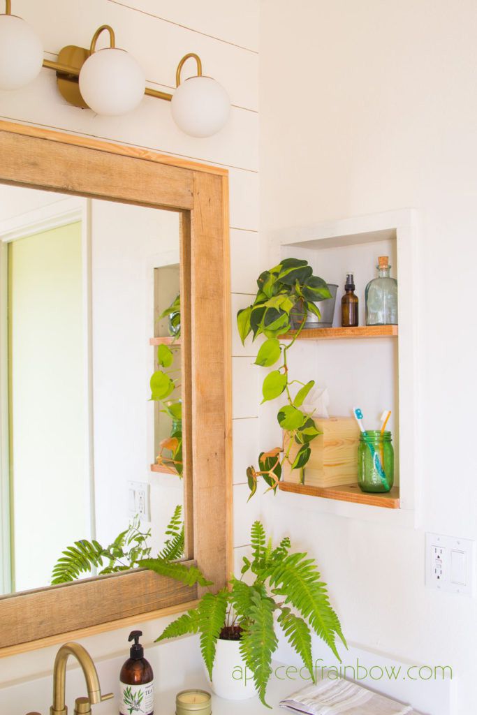 Offene Regale in einem hellen Badezimmer mit Grünpflanzen