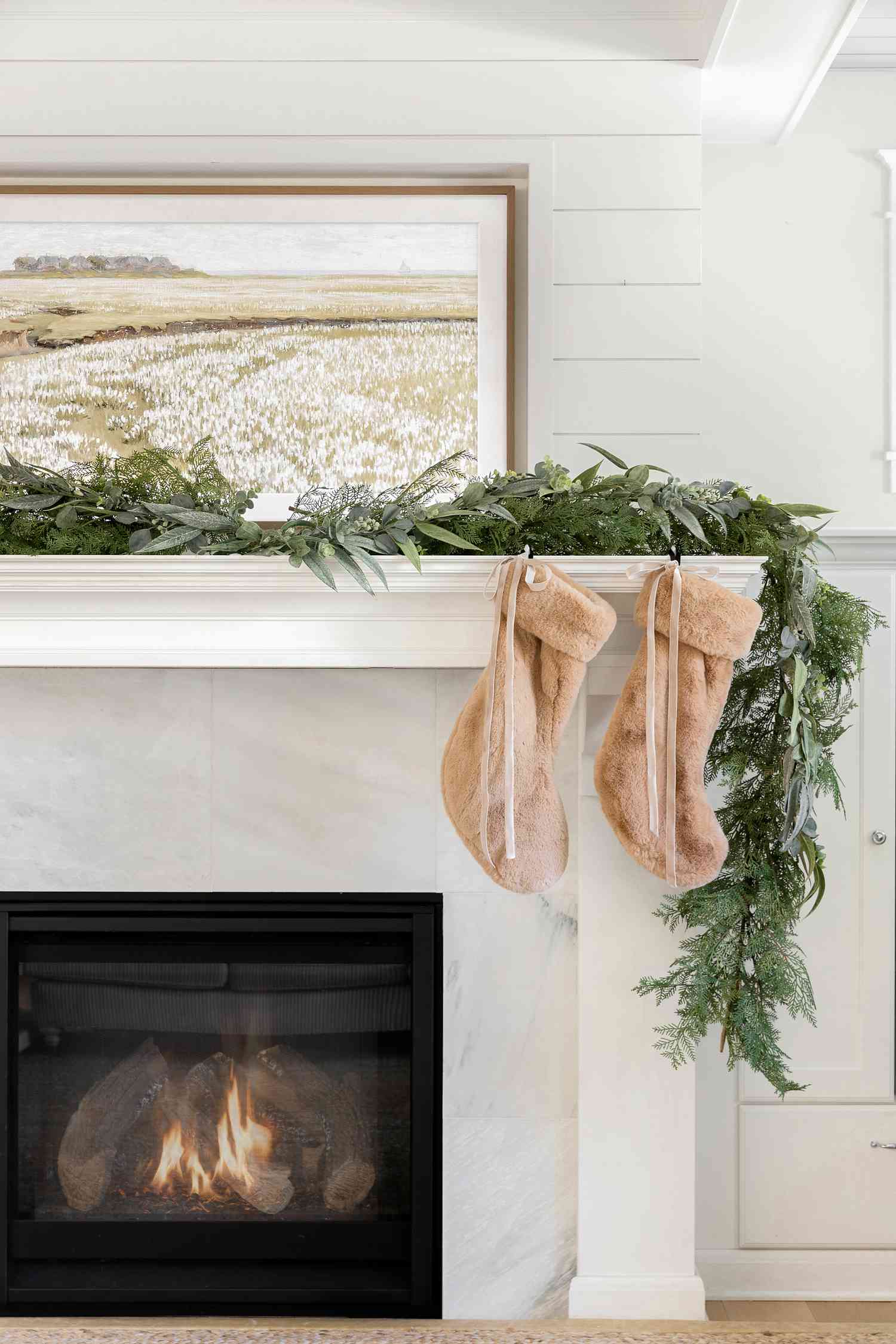 Neutral brown stockings hung on fireplace mantel.