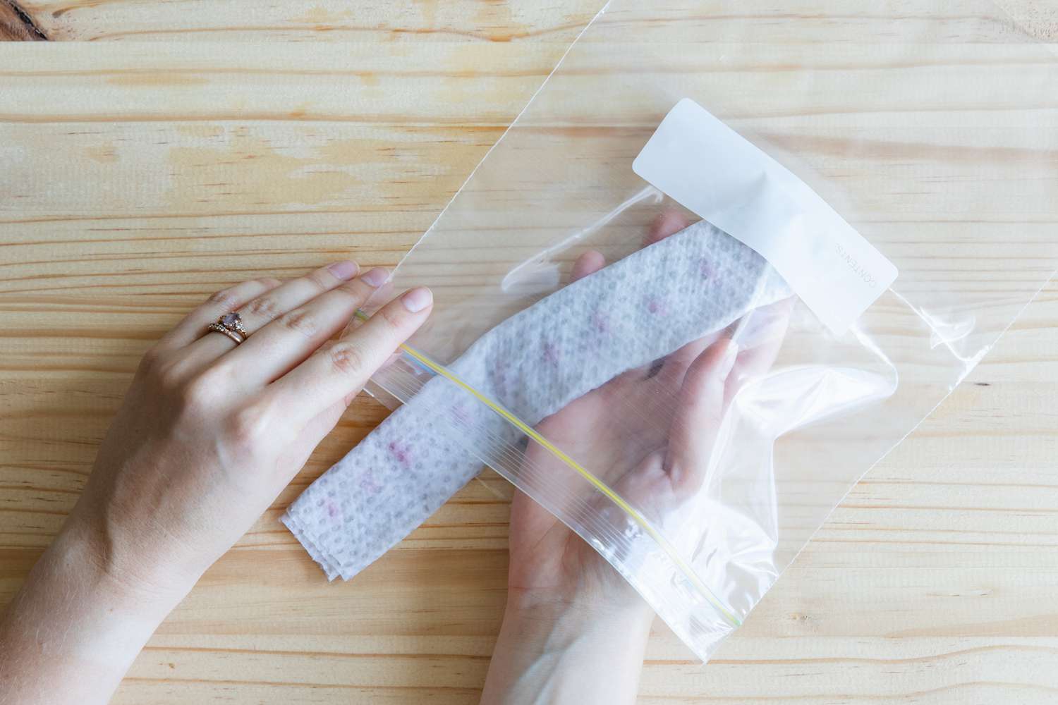 placing the rolled up seeds in a plastic bag