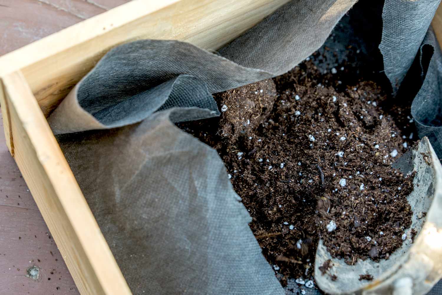 Adding soil to the planter box
