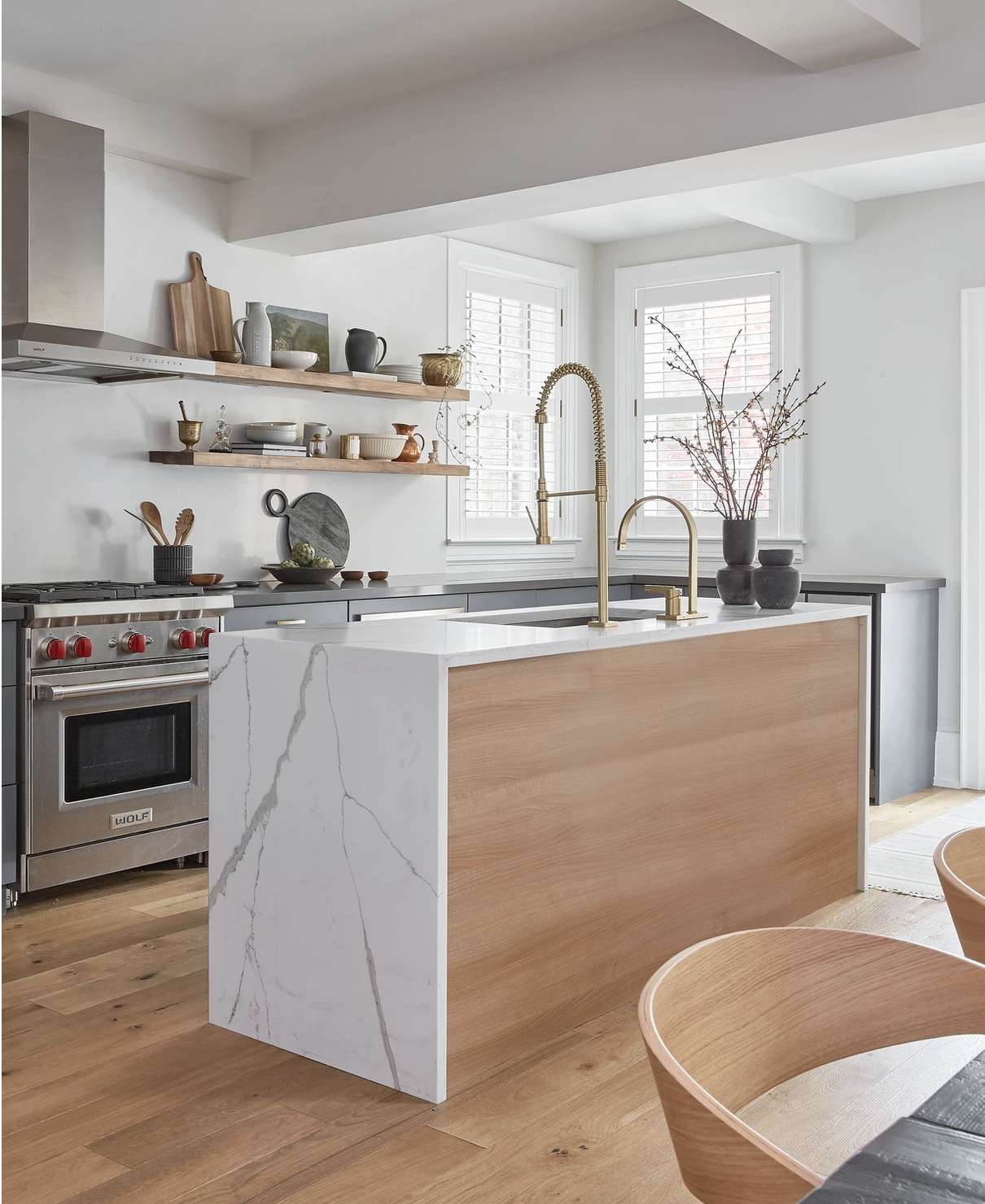 cozinha branca moderna com ilha de mármore e detalhes em madeira quente