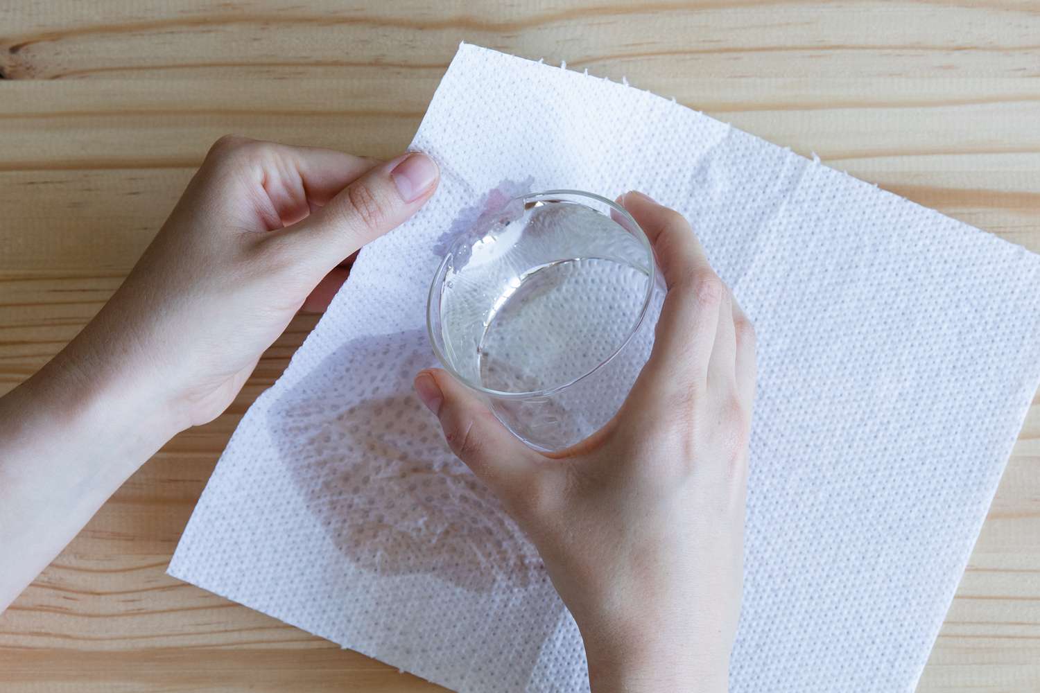 person moistening a paper towel