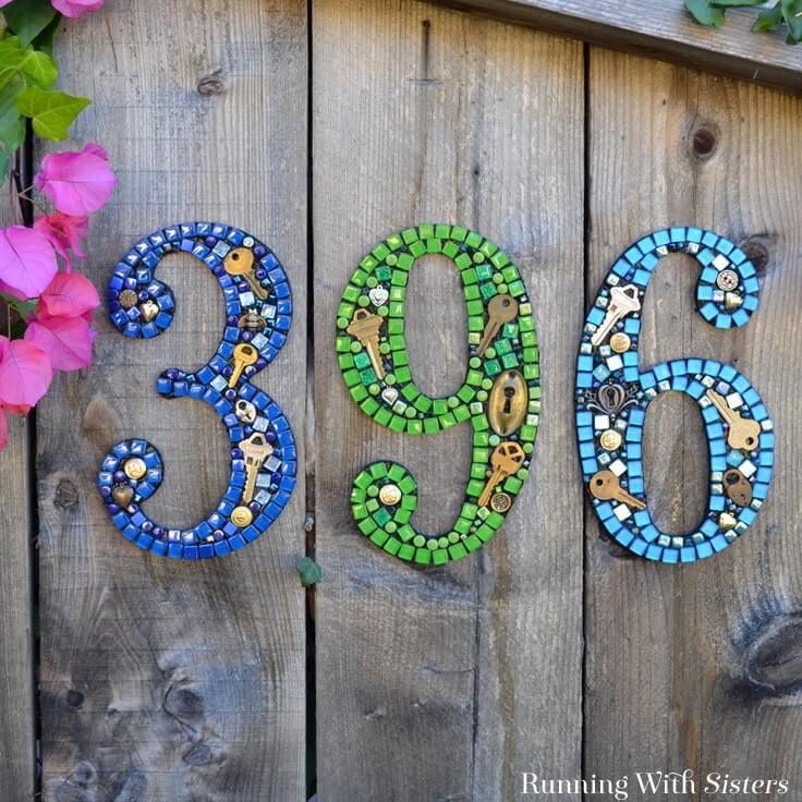 Mosaic house numbers hanging on a fence
