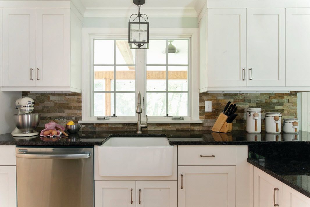 stacked stone backsplash in a farmhouse kitchen