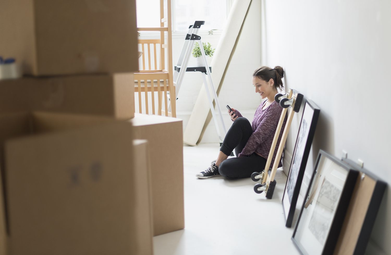 Young woman moving into new flat