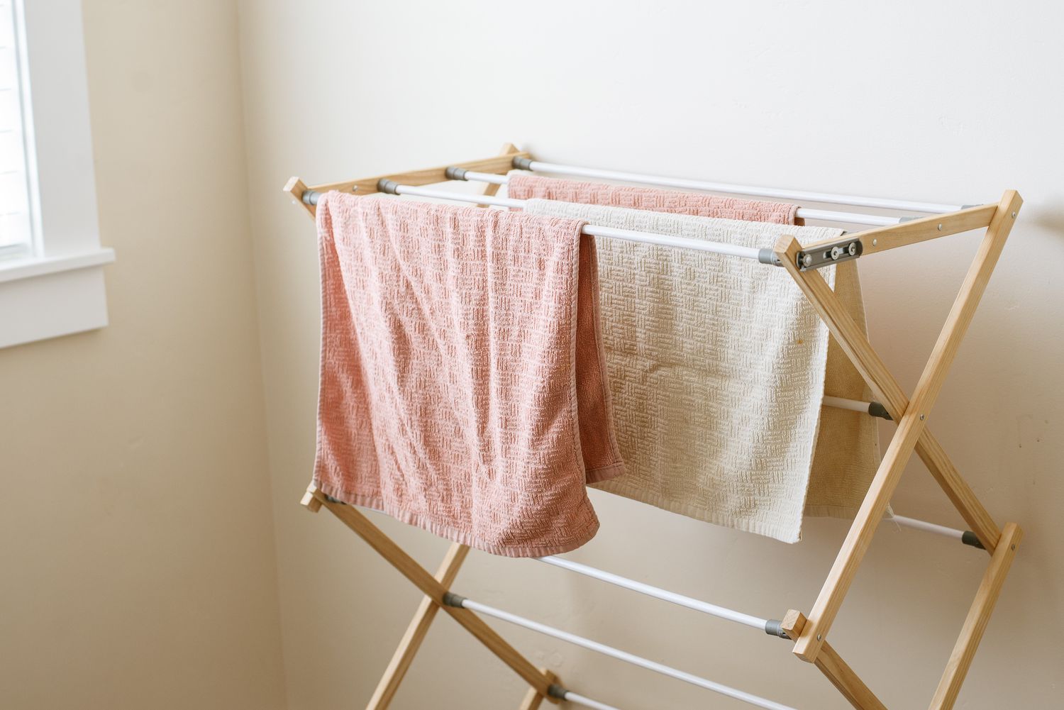 Wäscheständer mit orange- und cremefarbenen Handtüchern