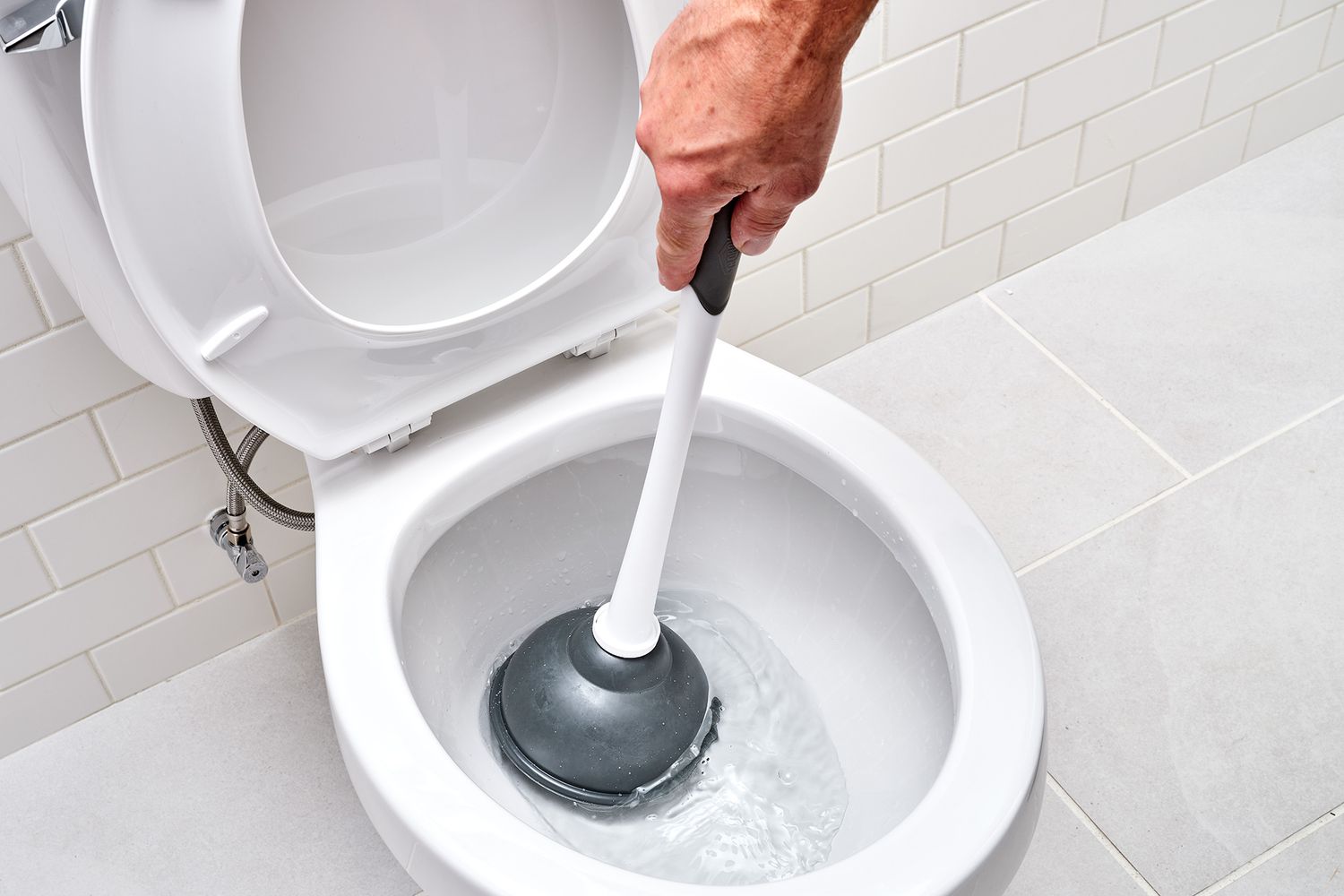 Toilet plunger placed over hole to create a seal