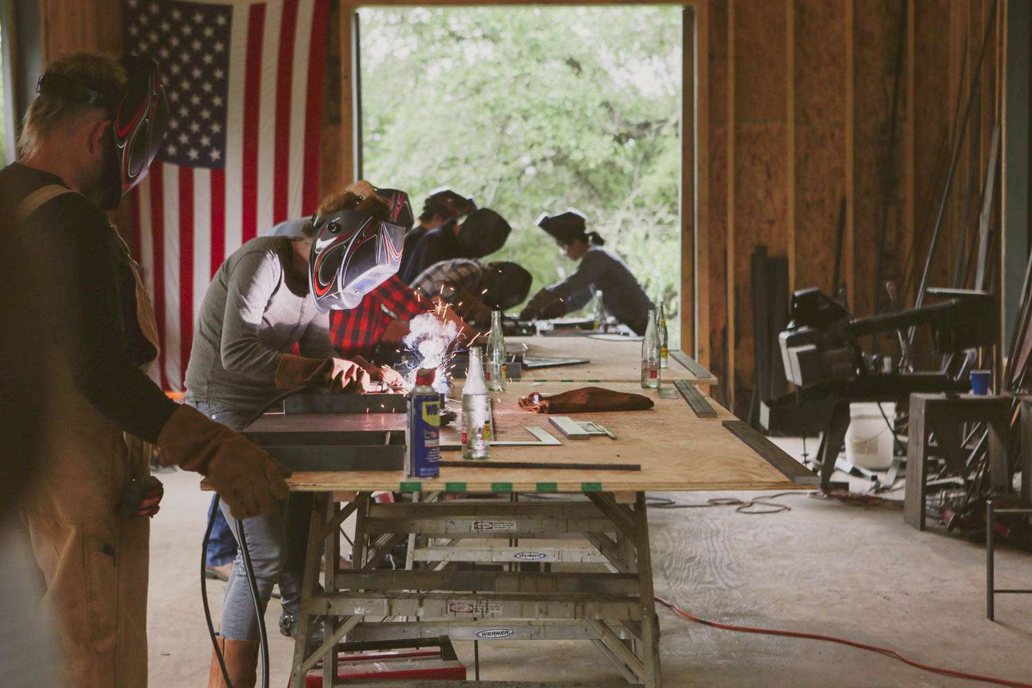 Makers welding on a work table.