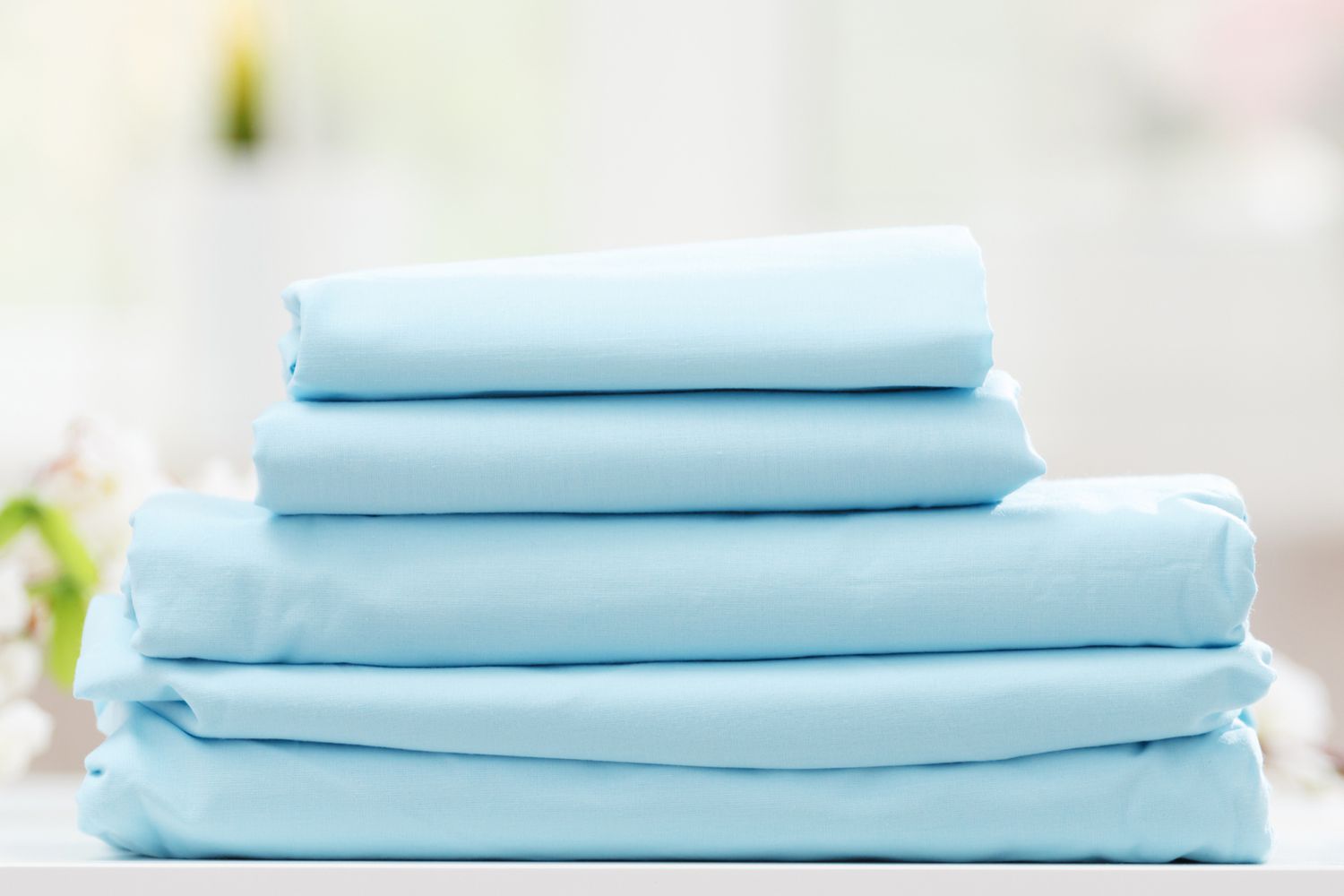 Stack of cotton percale bed sheets